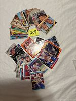 Overhead view of fanned pile of baseball cards with variety of designs