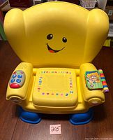 Front view of yellow Fisher-Price interactive chair