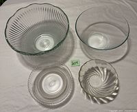 Overview of four clear glass bowls displayed on table