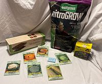 Group shot showing all items: grass seed bag, heat mat box, grow pod box, seven seed packets