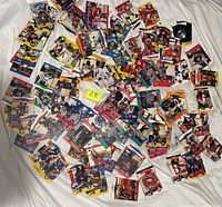 Overhead view of large pile of hockey cards spread on white surface