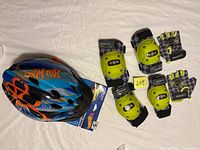 Helmet with pads and gloves laid out