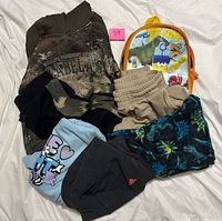 All clothing items and backpack grouped