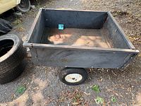Top view of garden trailer bed showing interior and one wheel