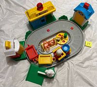 Overview of entire train set with track, buildings, cars and accessories