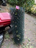 Full height view of rolled green chain-link fence