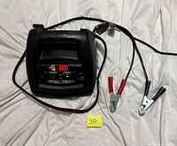 Front view of Schumacher charger showing control panel and clamps