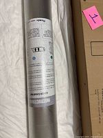 Rolled clear mat showing instruction label