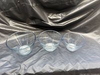 Three clear glass mixing bowls upright showing size comparison