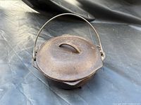Cast iron bean pot with lid and bail handle closed