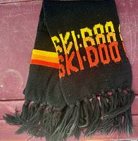 Folded scarf showing SKI-DOO logo and fringe