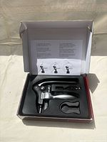 Open box showing lever corkscrew set components in foam insert