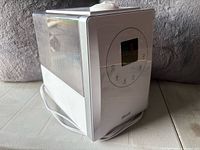 Front and side view showing full unit, tank, power cord