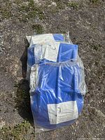 Two sealed blue skidplates stacked together showing instruction sheets in bags