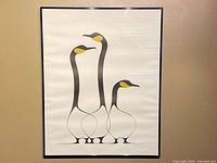 Frontal view of framed print showing full artwork of three Canada geese