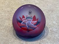 Front angle of Caithness White Tornado paperweight showing overall form and coloration