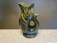 Front view of fish-shaped jug showing spout and body