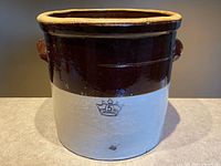 Front view showing crown stamp, two-tone glaze, side handles