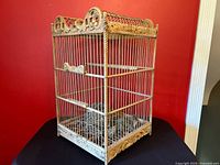 Full view of carved wood and wire birdcage