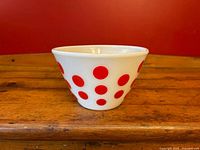 Side view of red polka dot milk glass bowl