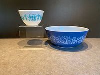 Both Pyrex bowls side by side showing size and pattern contrast