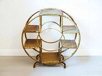 Front view of circular rattan shelf showing six shelves and legs