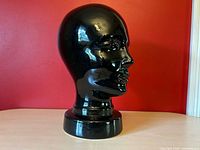 Right profile of ceramic head showing sculptural detail and shine