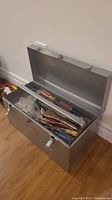 Open Craftsman metal tool box showing assorted tools inside