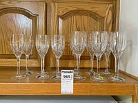 Full set of 12 Mikasa crystal wine glasses on shelf