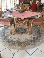 Full view of glass-top table on rug