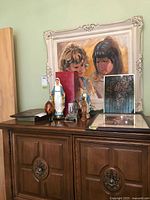 Overall lot on cabinet showing statues, framed art, rosary box and plaque