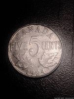 Reverse side of 1924 Canada 5 cents coin, maple leaf design and date visible