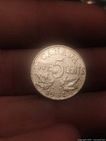 Reverse of 1931 Canada 5-cent coin showing denomination and date