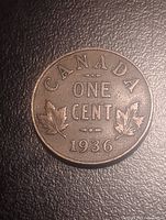 Reverse of 1936 Canada one cent coin showing maple leaves and denomination