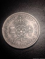Reverse of 1949 two shillings coin showing crowned rose, thistle, shamrock, denomination and date