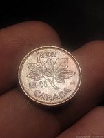 Reverse side showing maple leaves, date 1941 and denomination