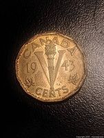 Reverse of 1943 Canada 5-cent coin showing torch and V design