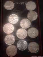All twelve Canadian 5-cent coins spread out showing reverse designs