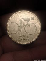 Obverse showing stylized bicycle with Cycling-Cyclisme text