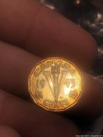 Reverse showing 1943 date, large V and torch