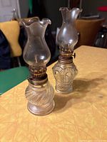 Both miniature oil lamps side by side showing size and design differences