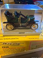 Green 1910 Stanley Steamer model car in acrylic case on Renwal box