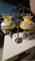 Front view showing full lamp with two yellow floral shades