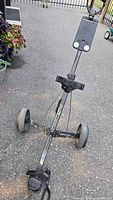 Full view of Bag Boy M-300 golf push cart standing on pavement