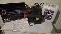fog machine, fog juice jug, remote, power cord, manual, box