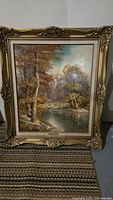 Full view of framed landscape painting