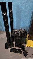 Complete system with towers, subwoofer, receiver, speakers, remotes, cables