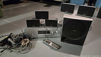 Full set showing receiver, five speakers, subwoofer, remote and cables