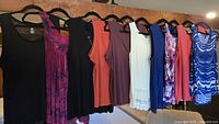 All ten tops hanging in a row showing full assortment