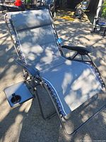Front angled view of oversized gray Timber Ridge zero gravity chair showing headrest, side tray, and laced suspension